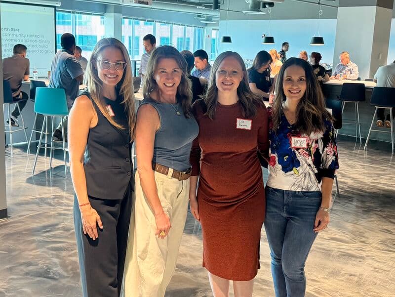 Four ProductTank Columbus organizers smiling together at a recent meetup event